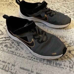 Nike Black and Gray Sneakers with Gold Swoosh